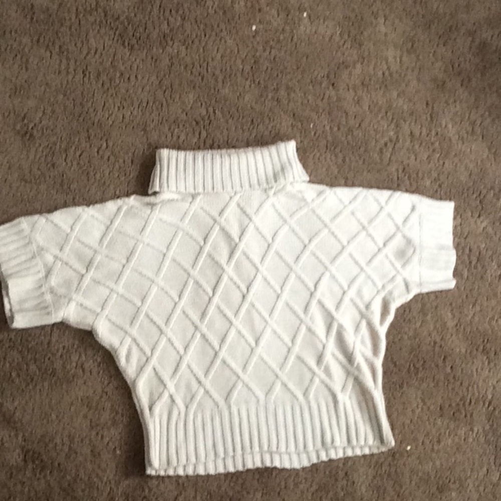 Khaki turtleneck sweater with 3/4 sleeves.